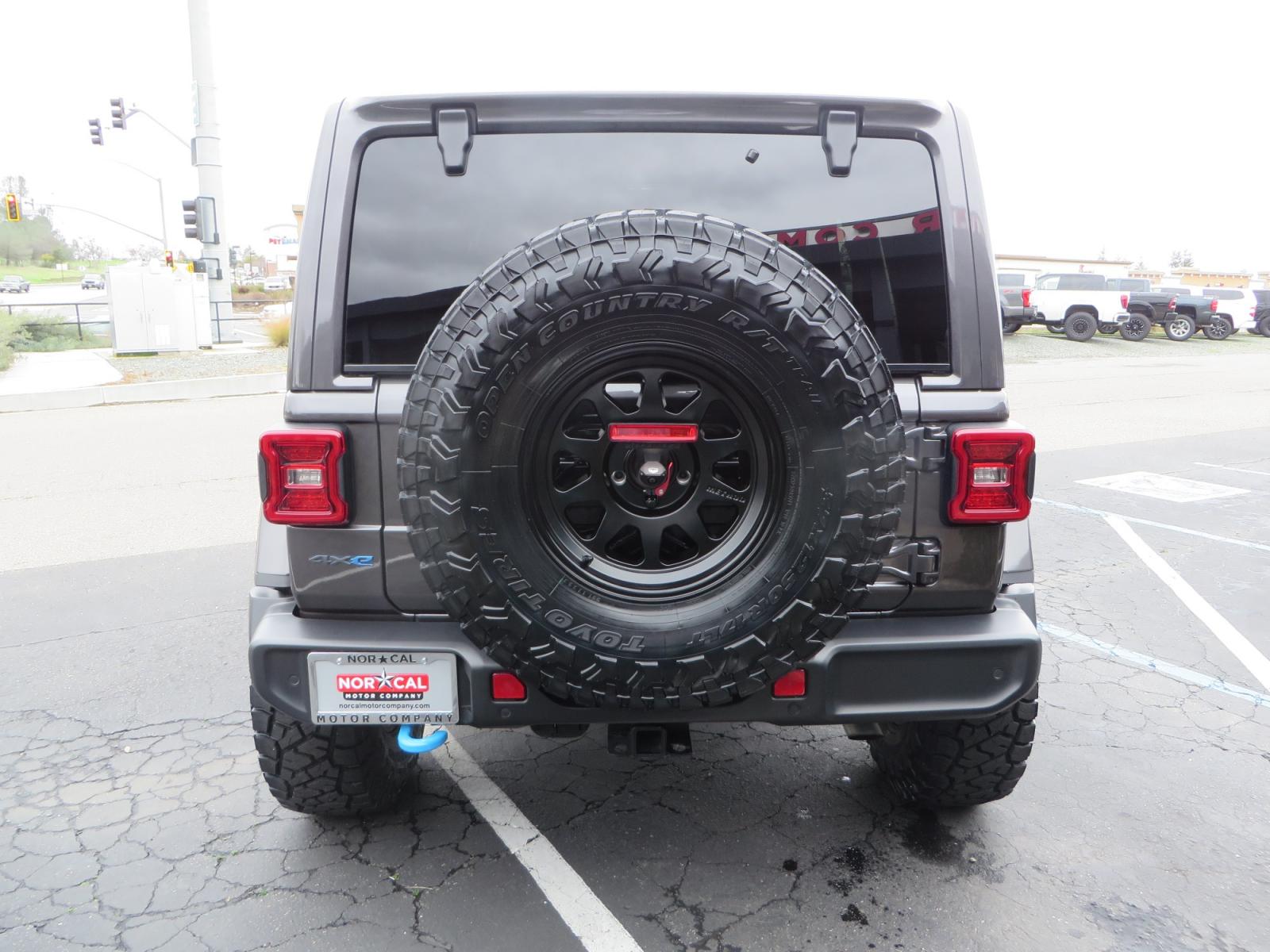 2021 CHARCOAL /BLACK Jeep Wrangler Unlimited Rubicon 4XE 4d SUV 4wd (1C4JJXR60MW) with an 2.0L L4 DOHC 16V TURBO engine, automatic transmission, located at 2630 Grass Valley Highway, Auburn, CA, 95603, (530) 508-5100, 38.937893, -121.095482 - 4XE Rubicon sitting on a Zone offroad suspension system, Fox shocks, 37" Toyo RT trail tires, 17" Method Race wheels, Teraflex Hd tire carrier, and Flat tow ready. - Photo #5